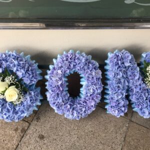 Son in blue hydrangea with White rose sprays